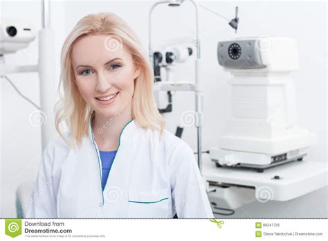 Attractive Female Ophthalmologist Is Working In Clinic Stock Image
