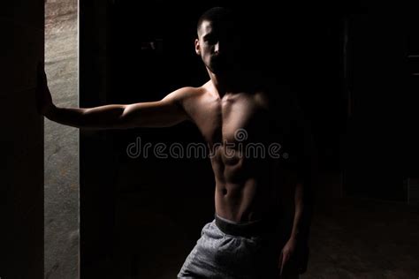 portrait of fit man in dark room stock image image of caucasian dark 115915955