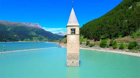 Church Tower In Lake Reschen South Tyrol Italy 4k Drone Photo