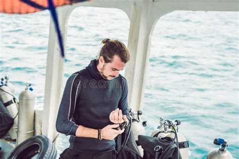 Young Diver Preparing An Underwater Compass For Diving Stock Image