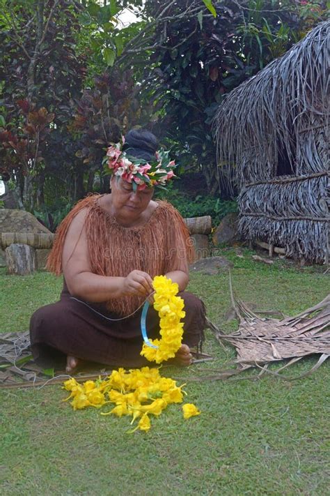 cook islander woman preppers yelow flowers wreath in a maori village in the highlands of