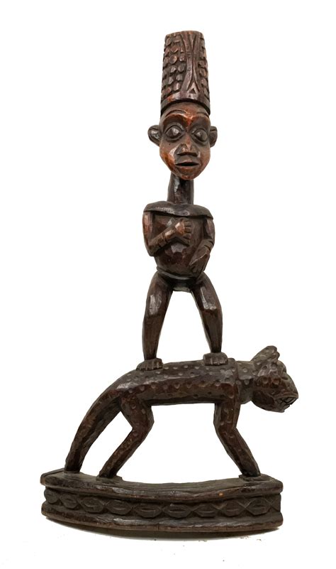 African sculpture of a figure standing on a leopard