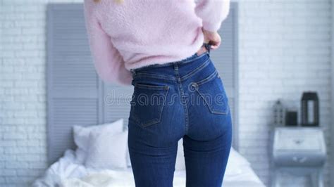 Overweight Woman Fitting In Tight Jeans In Bedroom Stock Footage