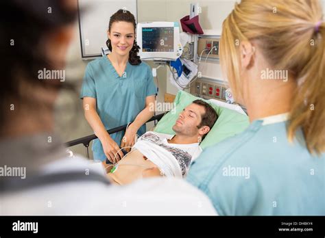 Nurses And Doctor Examining Patient Stock Photo Alamy