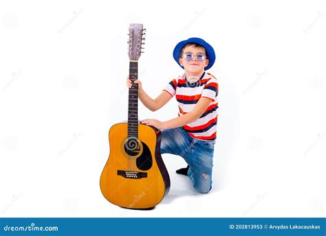 A Boy Kid Holding Guitar On A White Studio Background Stock Image
