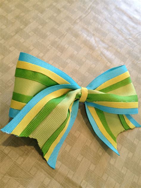 Our performance bows include rhinestone & glitter bows, paw prints, logo's, awareness ribbons, and personalized bows to top off. DIY cheer bow using 4 different ribbons!!🎀💚 | Cheer bows diy, How to make bows, Cheer bows