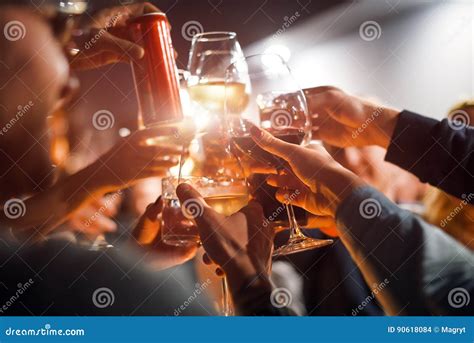 cheerful friends clinking glasses above dinner table alcohol and toasting party and