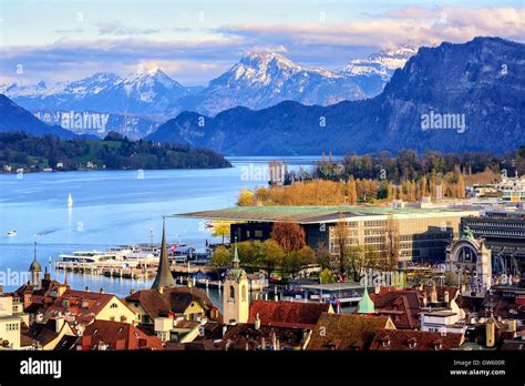 Lucerne Old Town And Culture Center Building On Lake Lucerne With Snow Covered Alps Mountains In