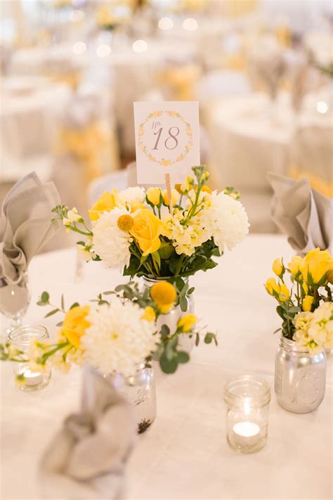 You just need a few wedding decorations used to maximum effect. Yellow and White Centerpiece with Mums and Craspedia