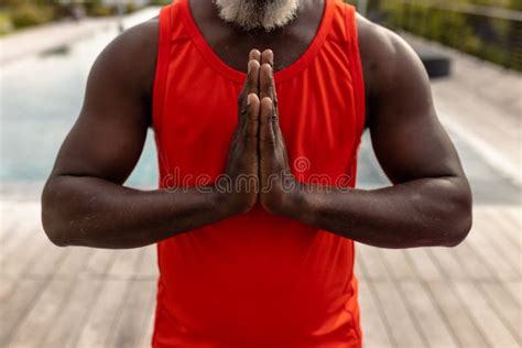 Midsection Of African American Senior Man Meditating In Prayer Position