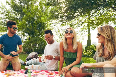 Five Adult Friends Picnicking In Park 35 To 39 Years Diversity