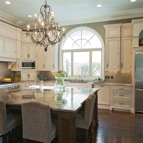 Though this designer opted for white cabinets on most of the kitchen, adding a deep gray pantry is a great way to add dimension to the space. 80+ BEST Simple And Elegant Cream Colored Kitchen Cabinets Design Ideas | Cream colored ...