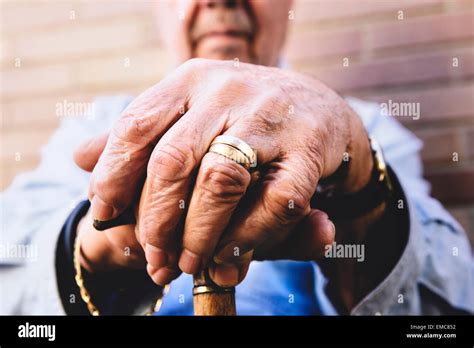 Close Up Of Old Mans Hands Resting On A Cane Stock Photo Alamy