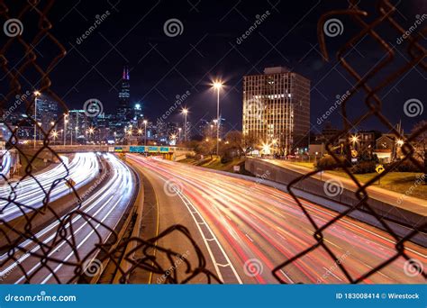Long Exposure Shot Of The Cars On A Highway Captured Through The Fences