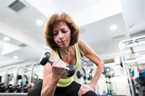 Senior Woman In Gym Working Out With Weights Stock Photo Image Of