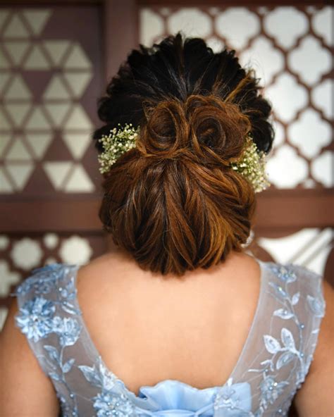 This hairstyle is a bit more bold that other hairstyles for wedding functions. Trending Bun Hairstyles for your Wedding Reception - K4 Fashion