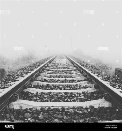 Railroad Tracks In Foggy Weather Stock Photo Alamy