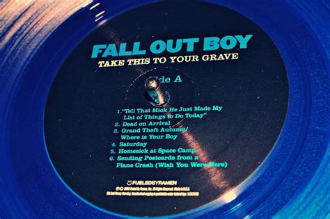 A Blue Disc With The Words Fall Out Boy On It S Side And An Image Of