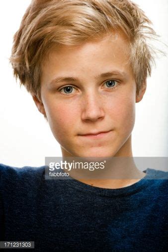 Boy With Blond Hair Blue Eyes Blue Pullover Looking Directly Into The