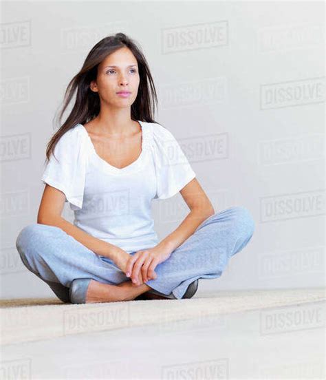 Woman Sitting Cross Legged On Floor Stock Photo Dissolve