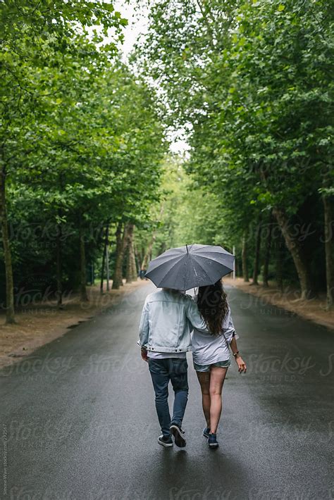 Couple Walking Together Under The Rain By Simon Rain Couple Stocksy United