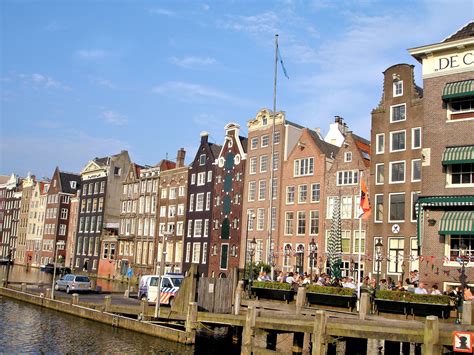 dancing houses on damrak canal in amsterdam netherlands encircle photos
