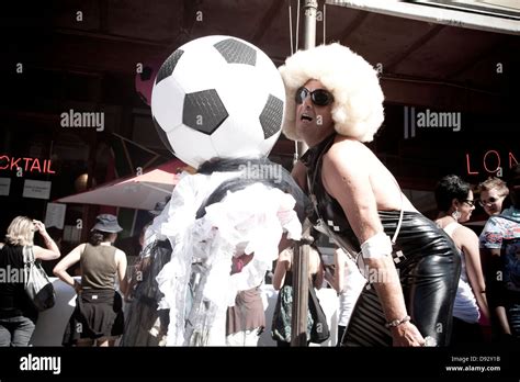 Football Fan Dressed Up As Drag Queen Next To Large Football During