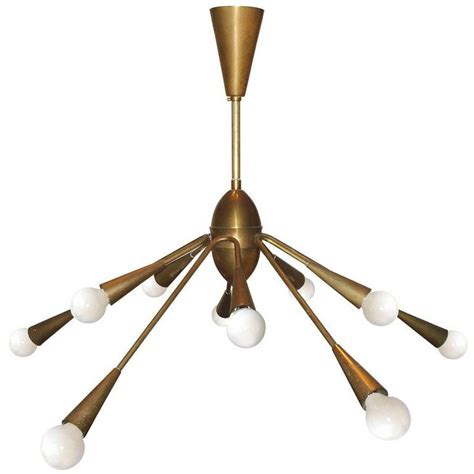 Lampada realizzata nelle finiture ambra, bronzo, cromo o fumè alternati a elementi decorativi in metallo bronzato o cromato e inserti in mosaico. Italian Brass Chandelier Lumi, Milano, Italy, 1950s ...