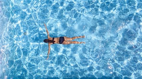 Premium Photo Active Girl In Swimming Pool Aerial Drone View From