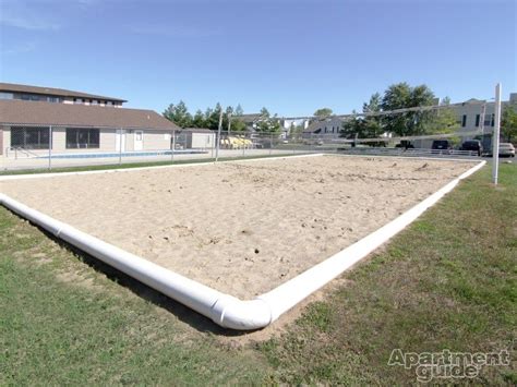 Sand pits sit in the center of two raised gravel beds, backed by low walls. Sand Volleyball Court in 2019 | Volleyball court backyard ...
