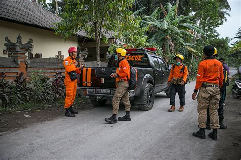 Members Of An Indonesian Rescue Team Search For Residents Around A