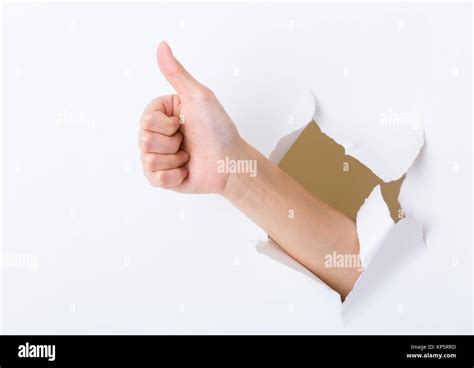 Hand Break Through Paper With Thumb Up Sign Stock Photo Alamy