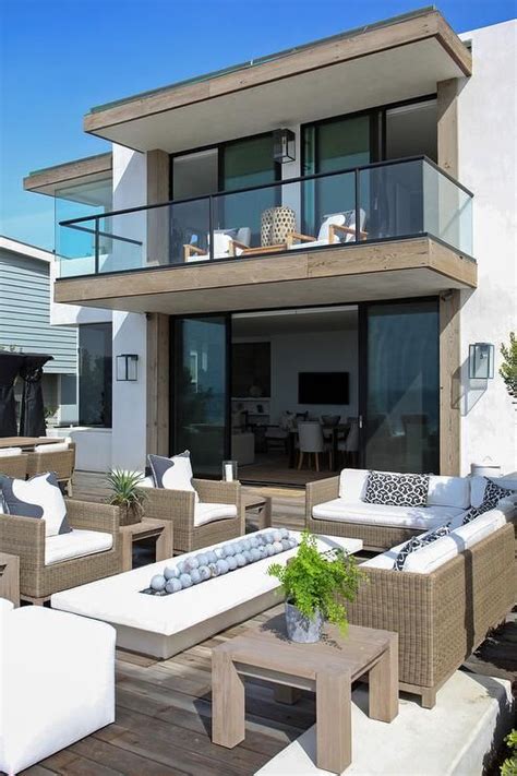 Oceanside Home Boasts A Second Floor Floating Balcony Shading A Patio