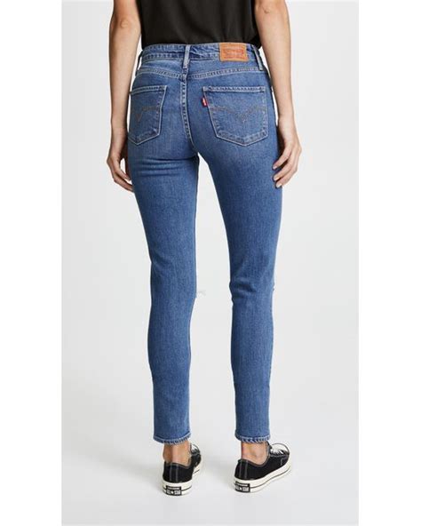 Levis 721 High Rise Distressed Skinny Jeans In Blue Lyst