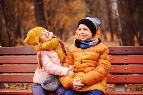 Autumn Portrait Of Happy Kids Playing Outdoor In Park Stock Photo