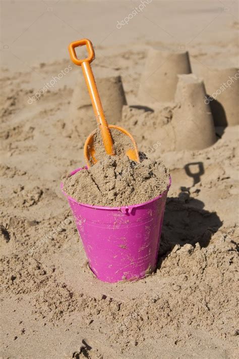 Bucket And Spade In Sand On The Beach Stock Photo Aoosthuizen
