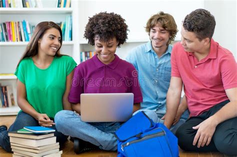 Group Of Hispanic And African American Students Learning At Computer
