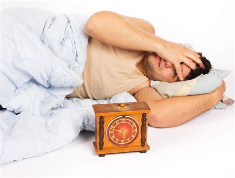 Young Man Wakes To A Loud Alarm Clock Stock Photo Image Of Emotion