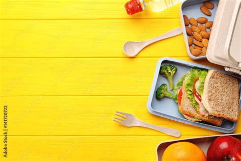 Healthy Food In Lunch Boxes On Yellow Wooden Background Photos Adobe