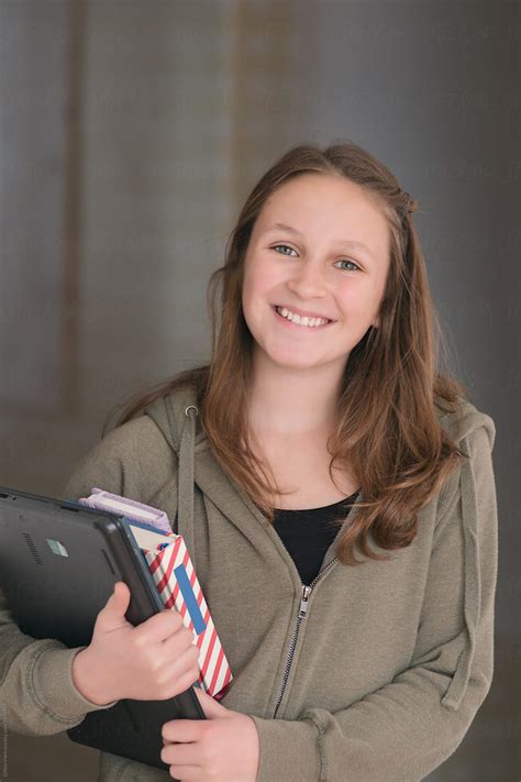 Portrait Of A Teen Grade 8 Student With Books And Laptop By Stocksy