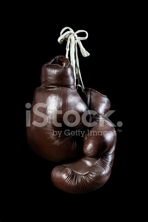 Old Boxing Gloves Hanging Isolated On Black Background Stock Photos