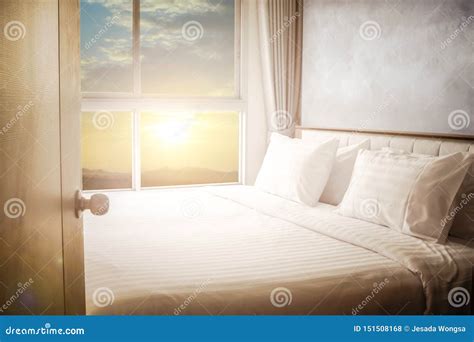Open Door To Bed In Hotel Room Bedroom White Bed Sheets Lit By Natural