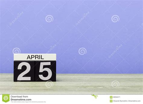 April 25th Day 25 Of Month Calendar On Wooden Table And Purple