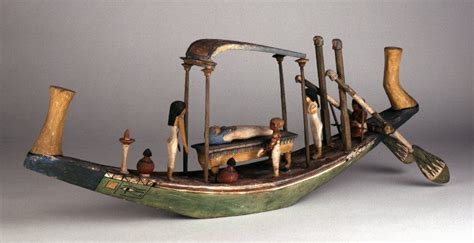 wooden model of funeral barge the hull is shallow with narrow beam graceful curve to sheer