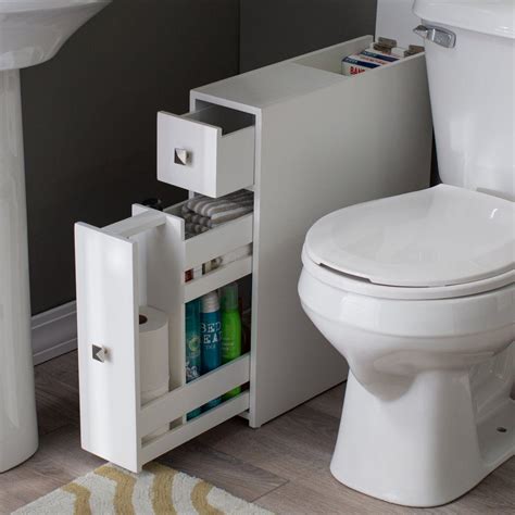 A White Toilet Sitting Next To A Sink And A Bath Tub In A Room With