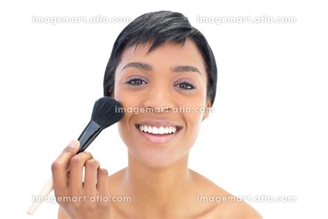 Delighted Black Haired Woman Applying Powder On Her Cheeks On White