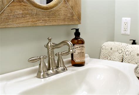 Inside the bathroom, flea market furnishings and vintage silhouettes, including the sink, faucet, and mirror, stack up for rustic pizzazz. farmhouse faucet - Choosing the perfect bathroom faucet!