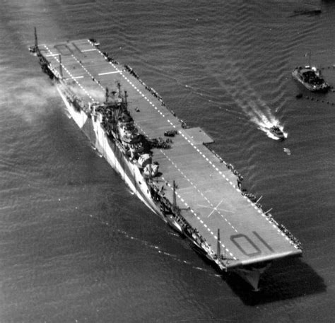 An Aerial View Of A Large Ship In The Water With Smaller Boats Nearby On It