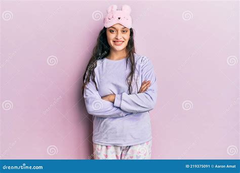 beautiful middle eastern woman wearing sleep mask and pajama happy face smiling with crossed