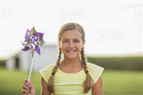 Caucasian Girl Holding Pinwheel On Farm Stock Photo Dissolve